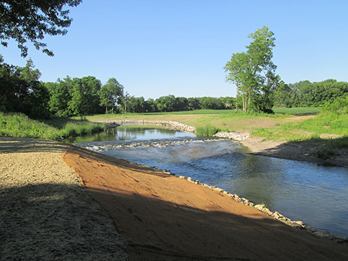 Stream with rocks lining the sides to prevent soil erosion