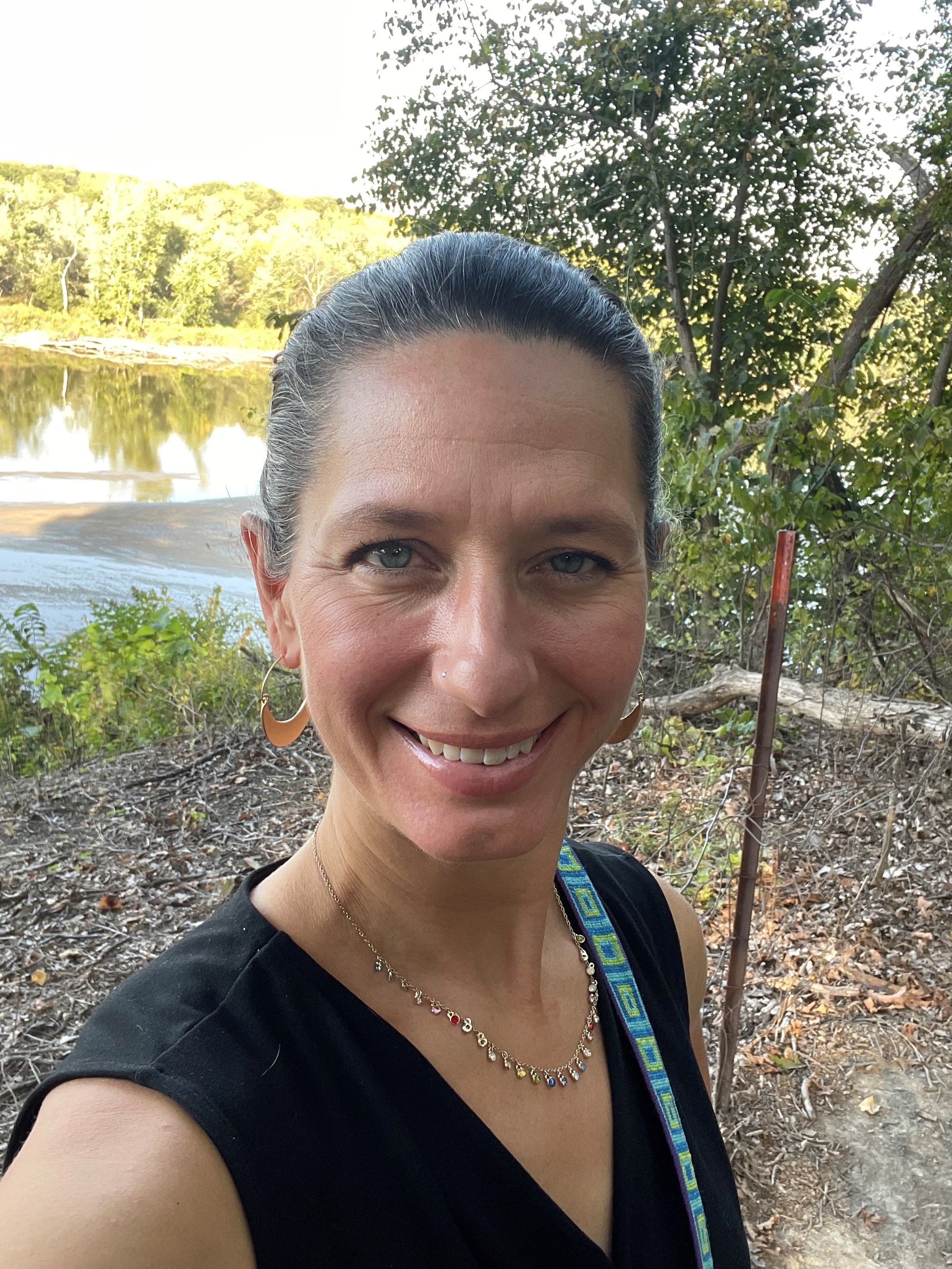 Mary Beth standing near river.