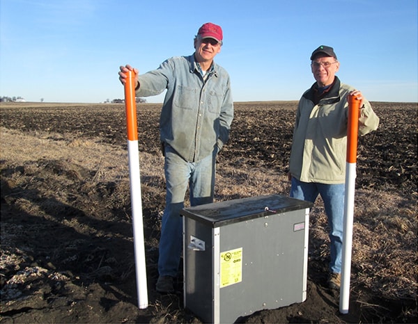 Farmer Tom Vincent (right) and landowner Roger Winterhof (left) have worked together to address water quality. They installed saturated buffers (pictured in the middle of the two), an Iowa innovation.