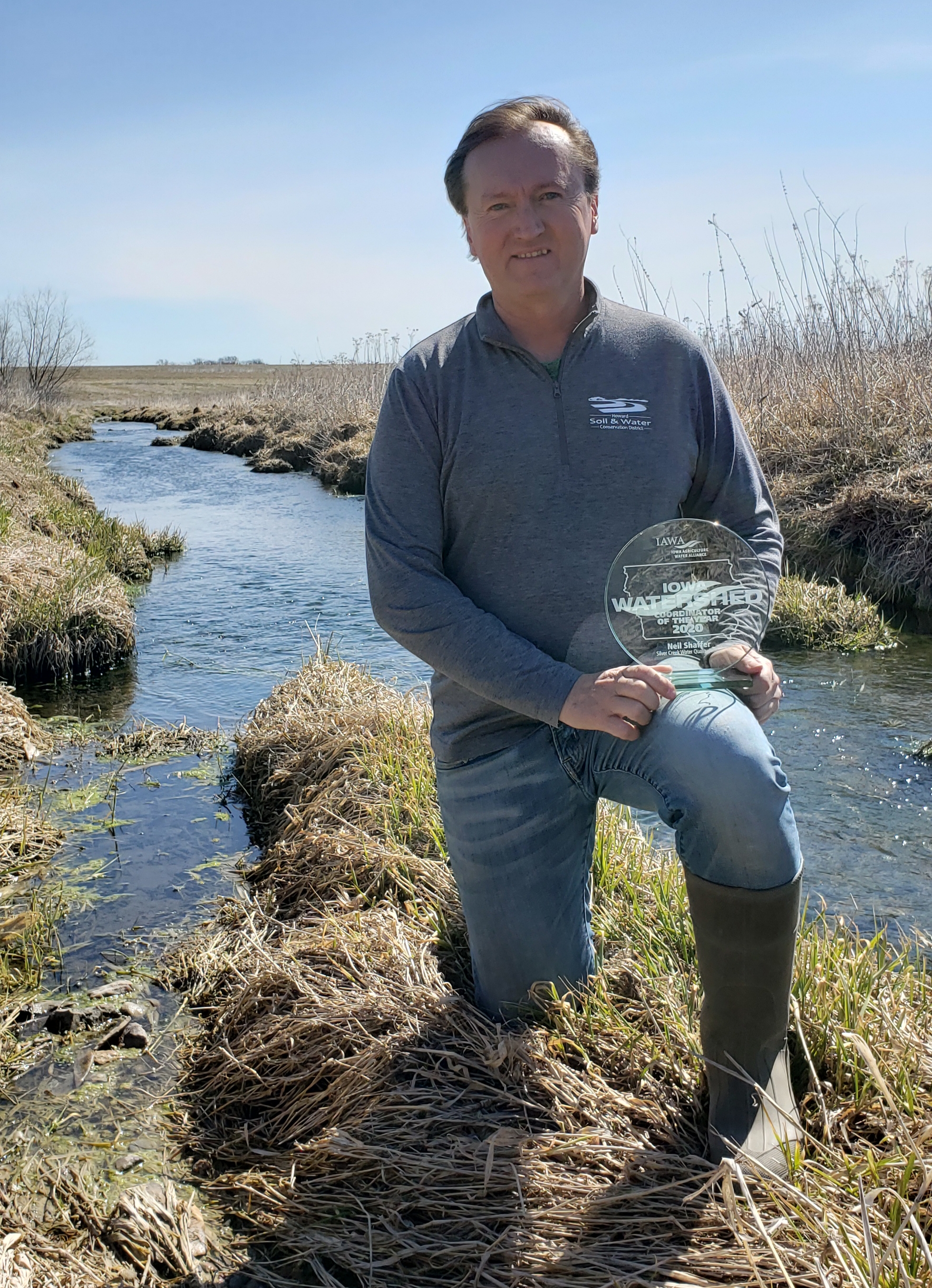 Neil Shaffer outside in front of waterway.